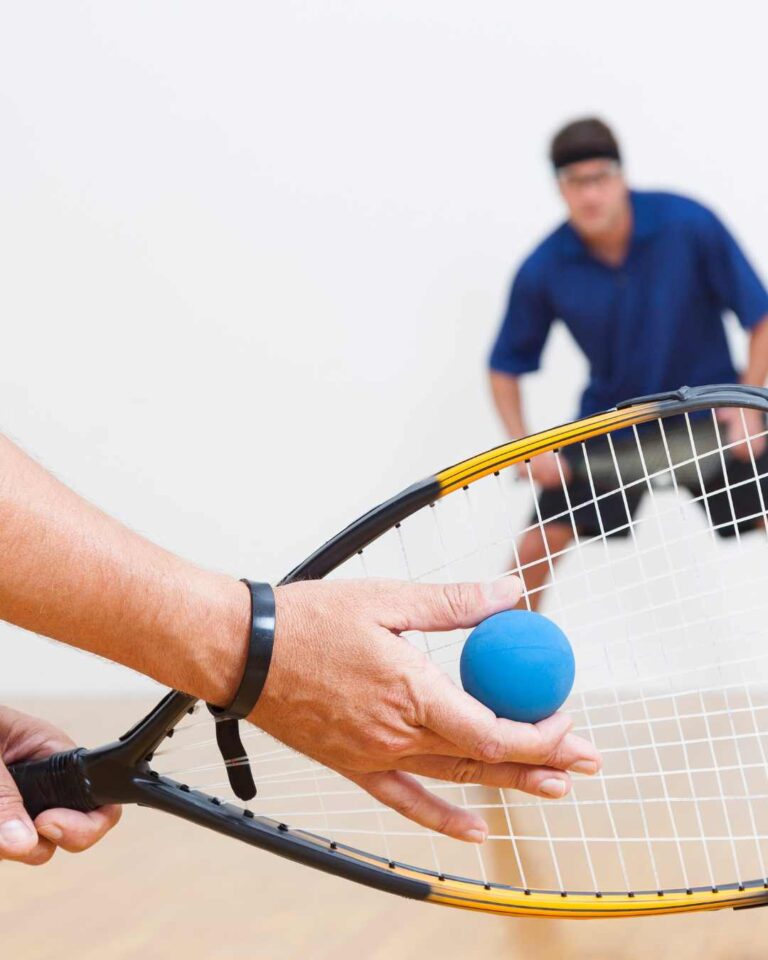 get into racketball, close up of a racketball racket and blue ball. exeter golf and country club